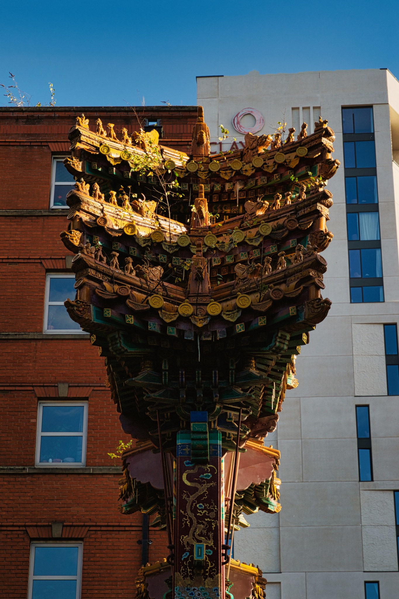 Chinese Temple Roof Against Modern Building in Manchester, UK.
